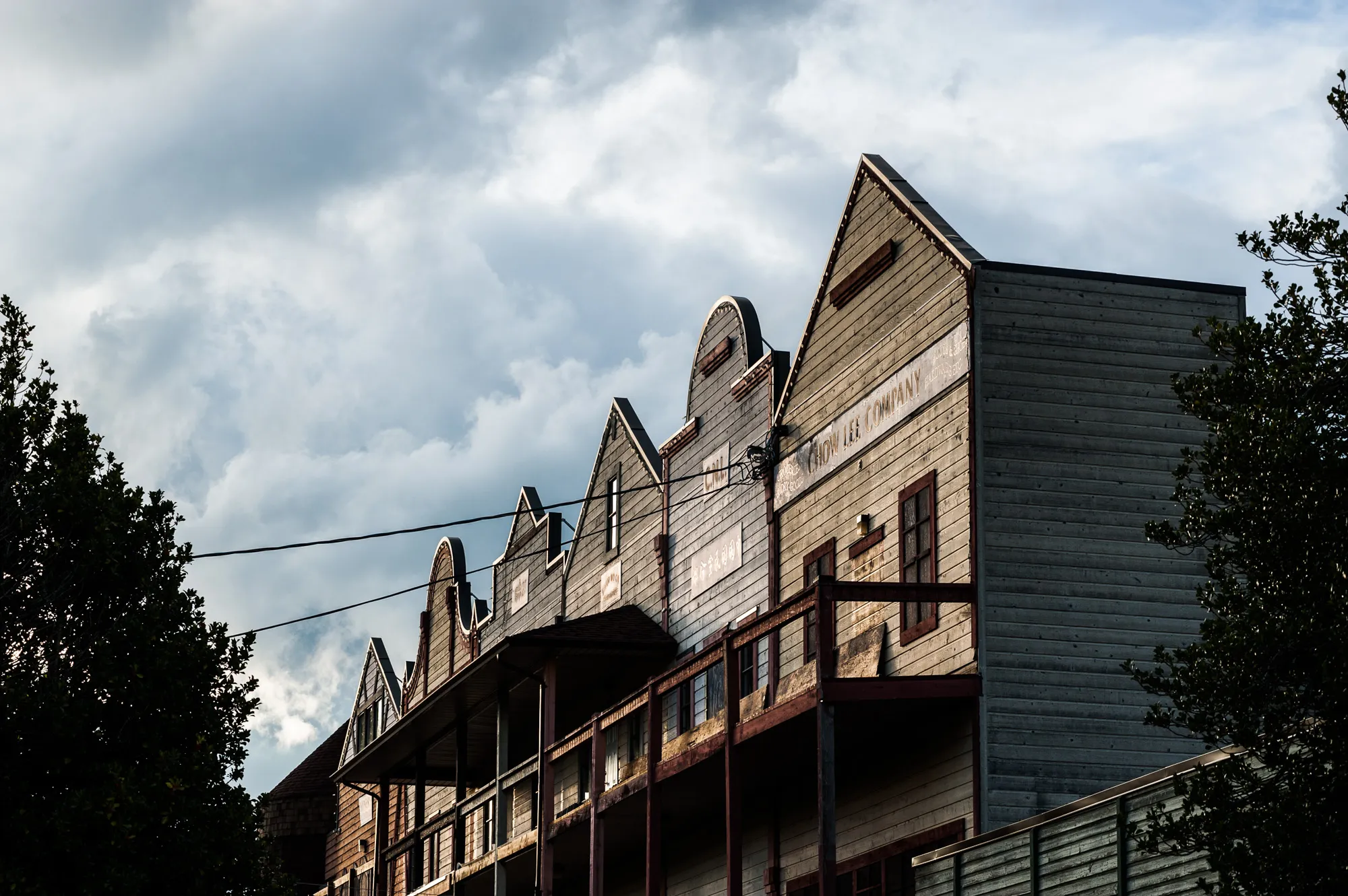 Historic wooden buildings beneath a dramatic sky in Cumberland, British Columbia